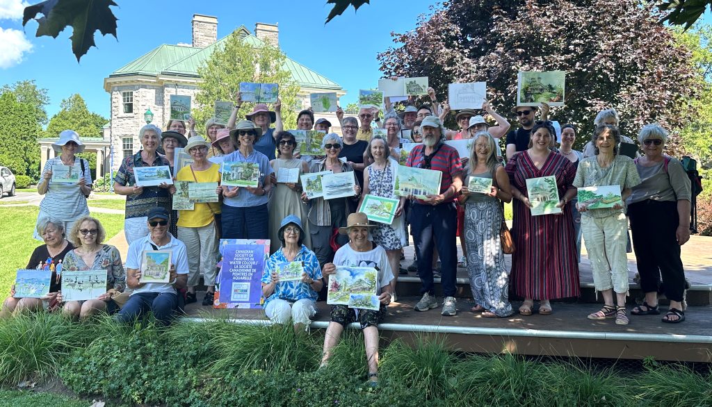 Shows a group of painters and sketchers, all holding up the work they did at Stewart Hall in Pointe Claire, PQ